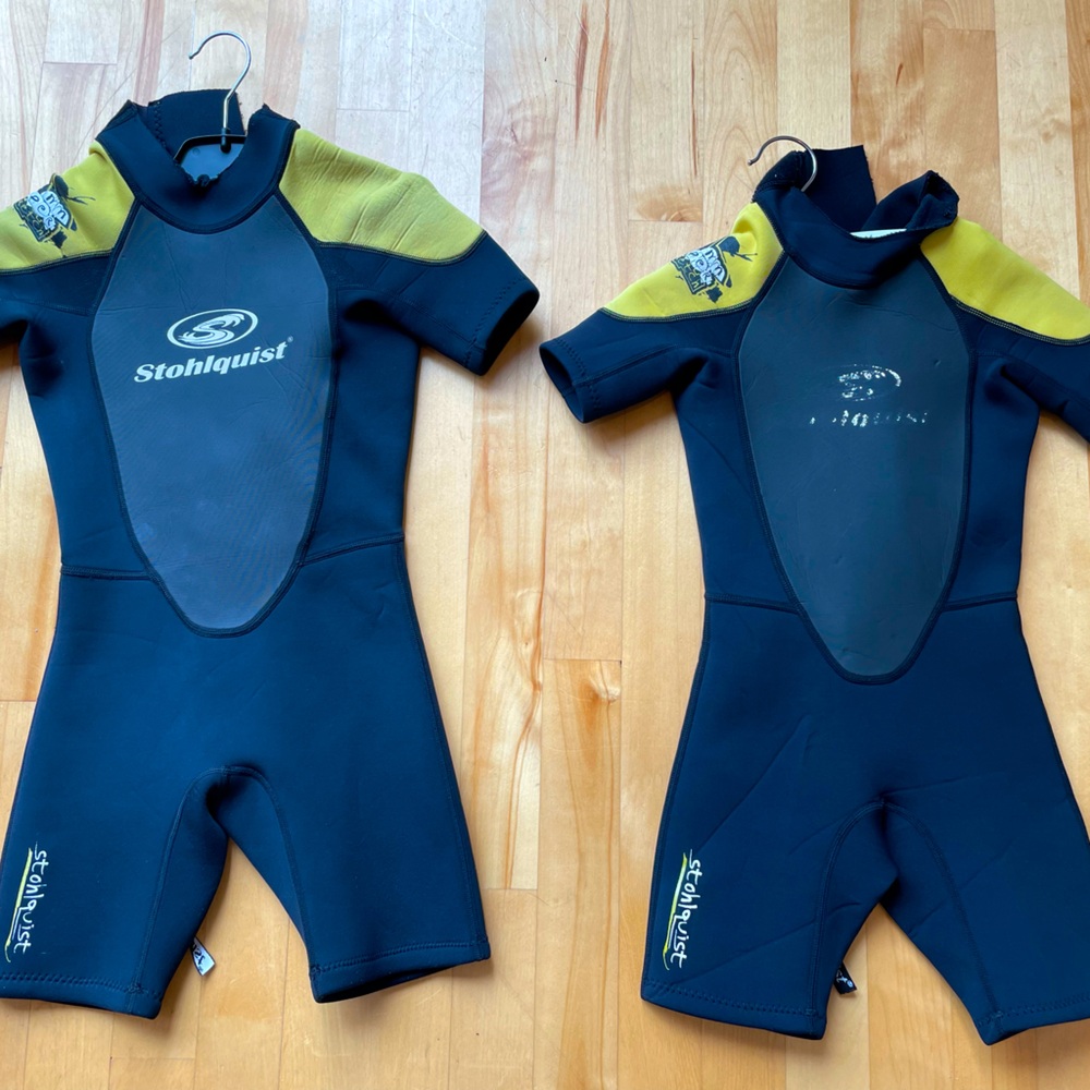 Two Stohlquist kids shortie wetsuits